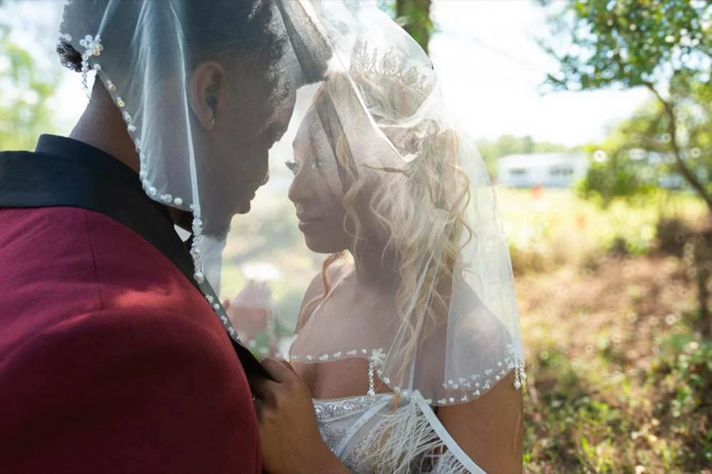 African American bride and groom under the veil