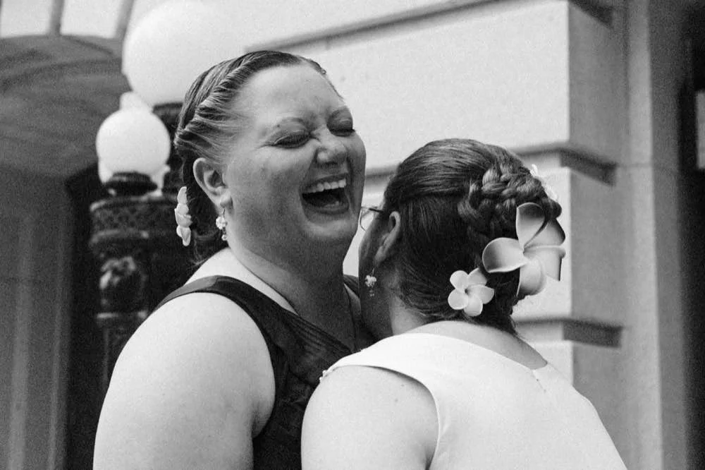 Black and White film photo of two brides laughing
