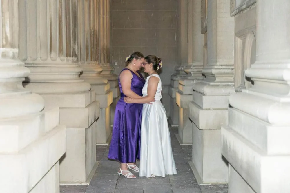 Intimate wedding portraits on historic library balcony