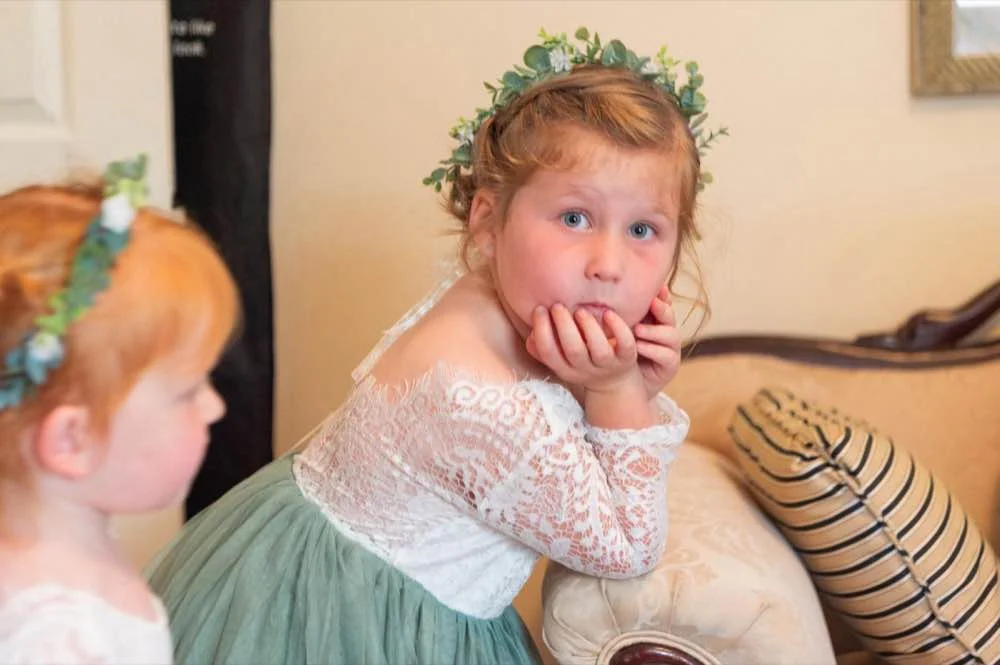 Candid flower girl in lace dress