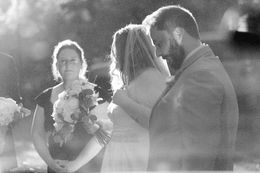 Grainy film photography of the 108 W Main wedding venue through a truck window